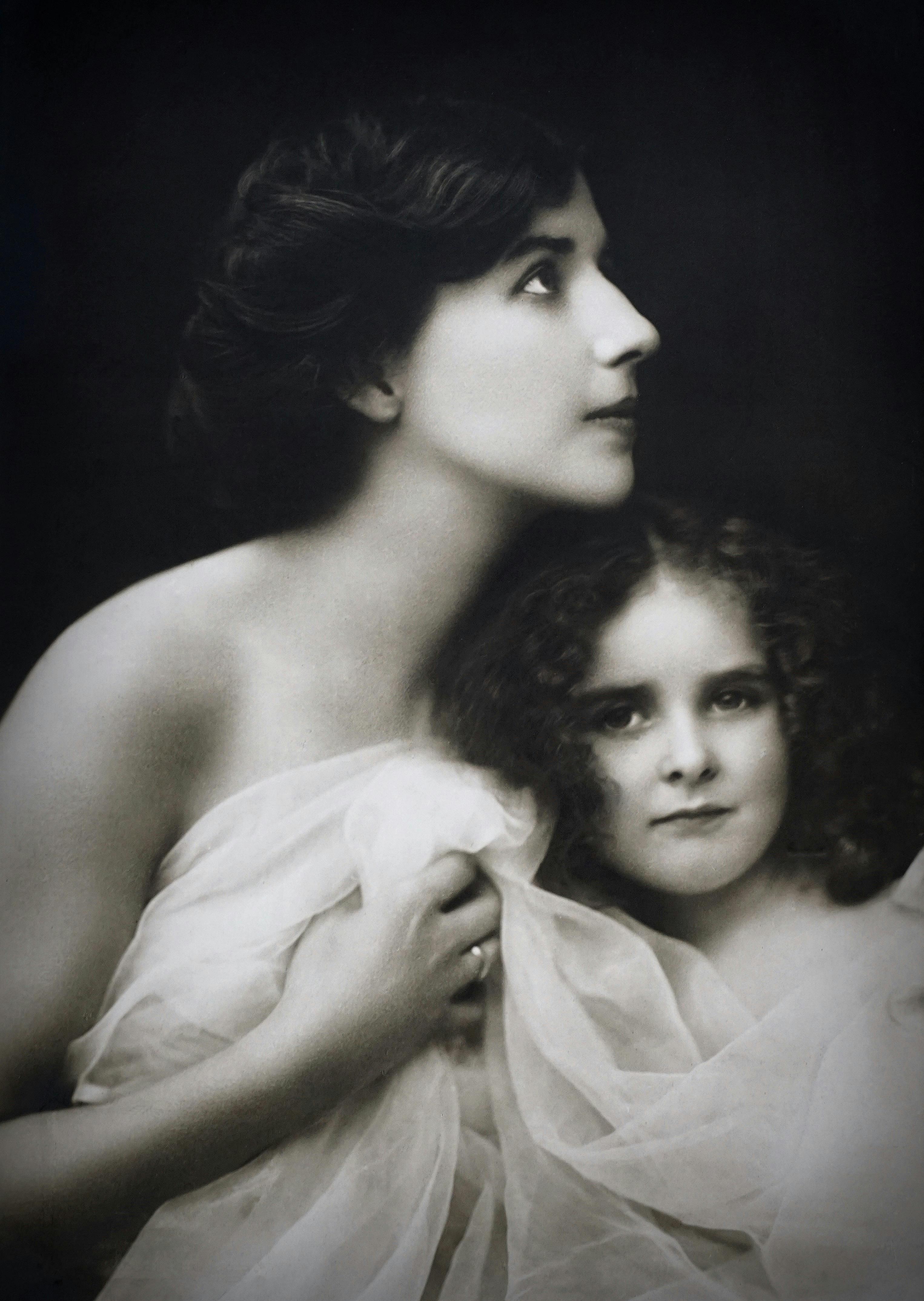 Monochrome Photo of Mother and Child Wrapped In White Cloth