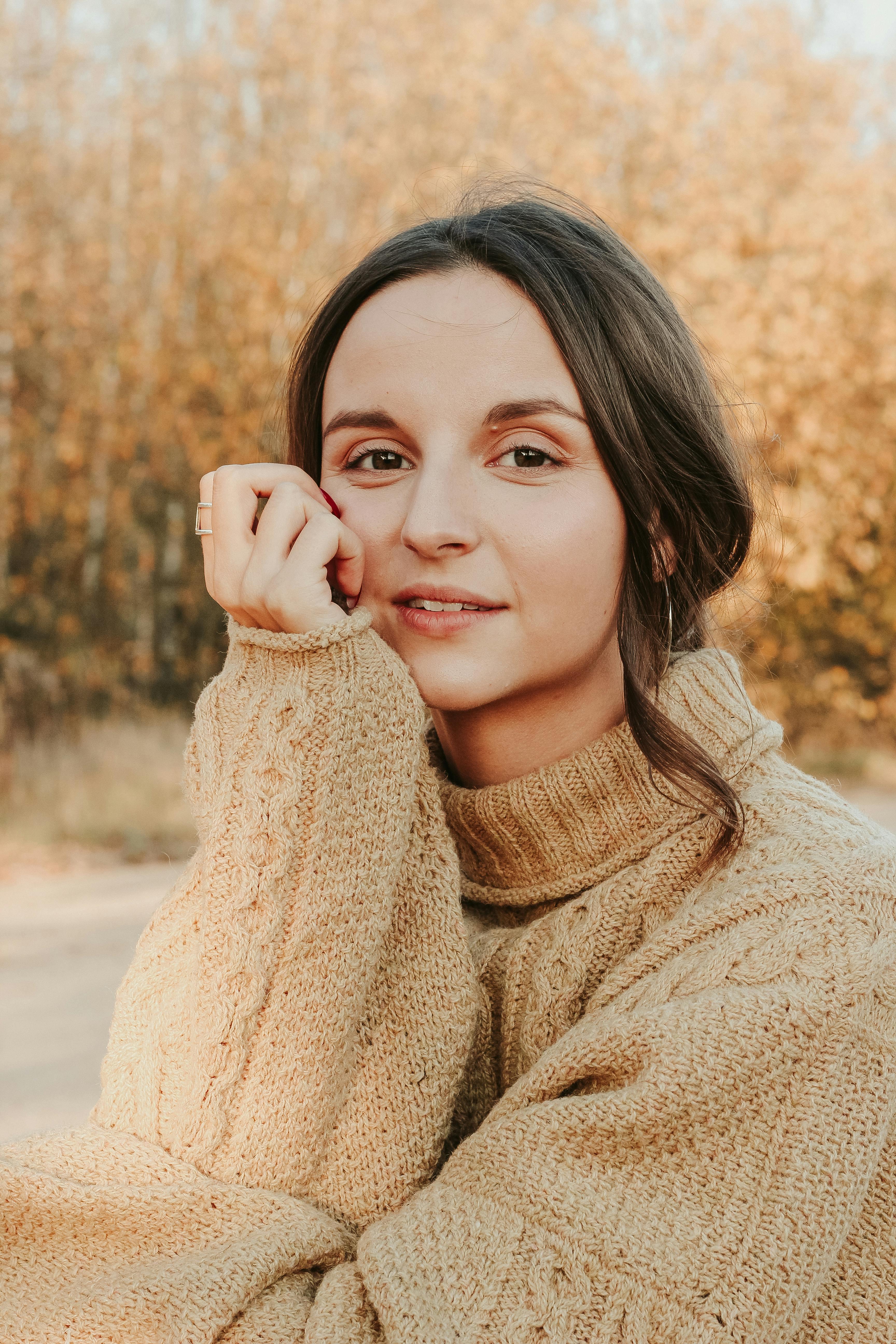 A woman in cozy knitwear enjoying a sunny autumn day in Minsk, Belarus.
