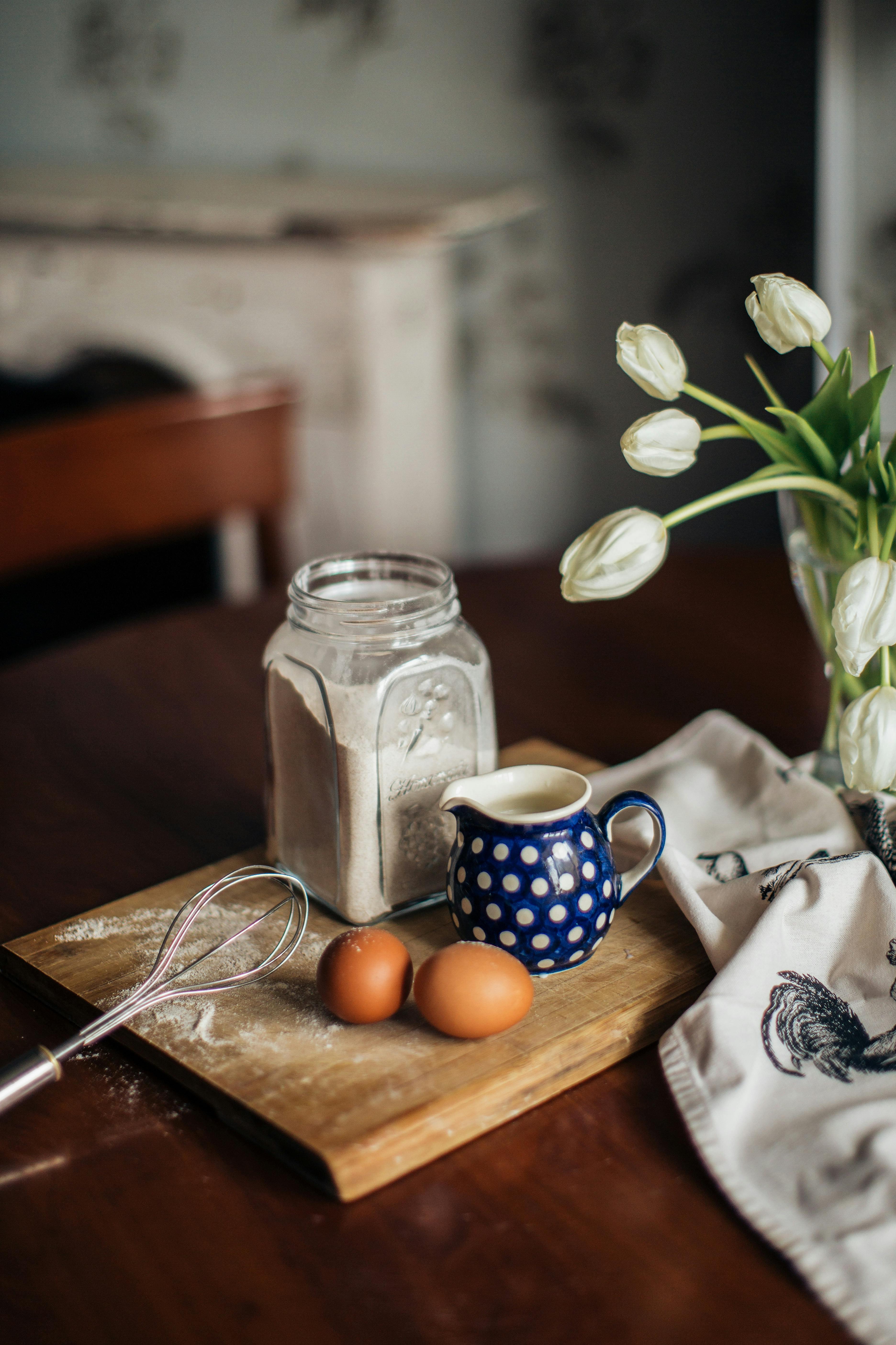 Ingredients for dough and flowers on table