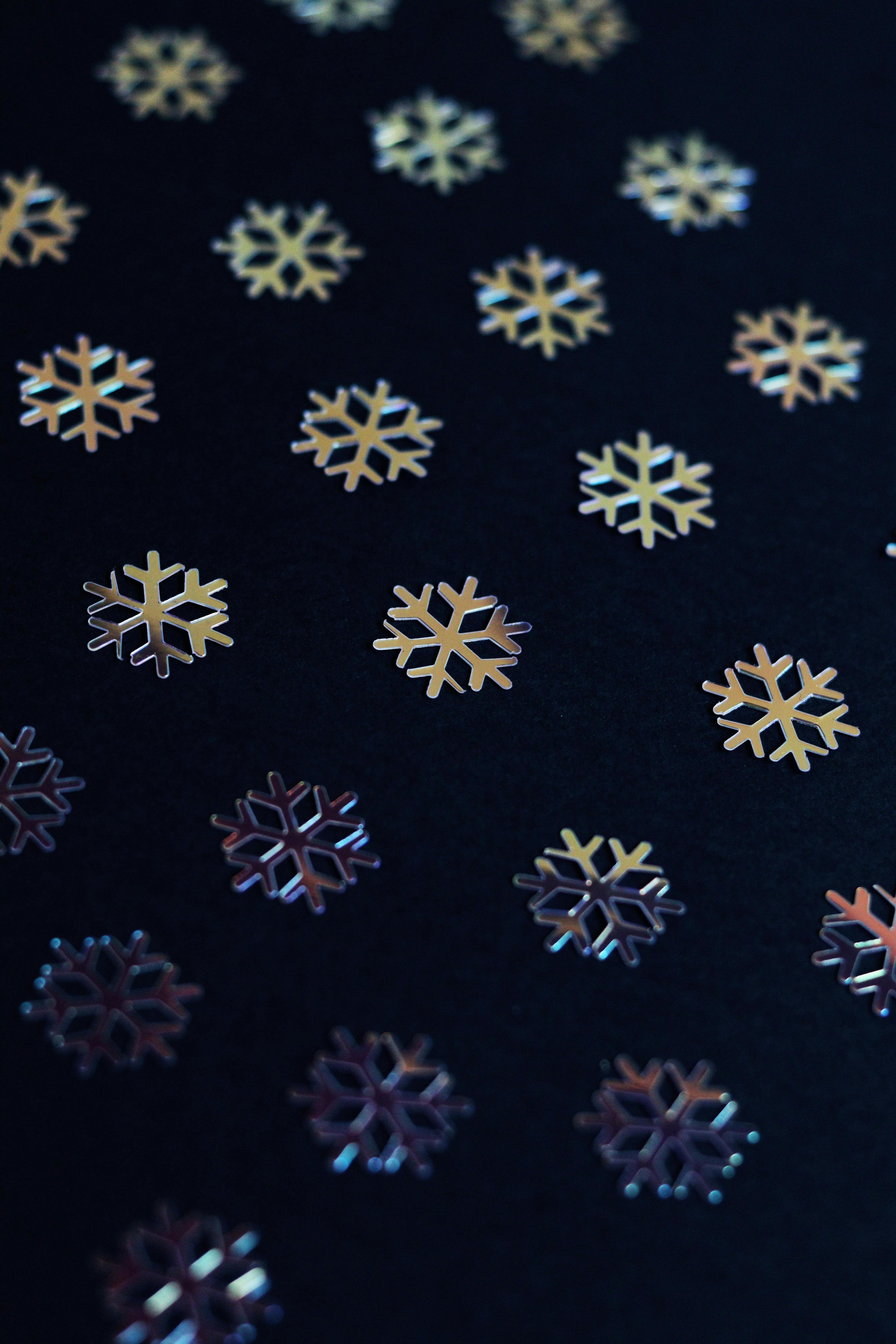 Intricate snowflake pattern on a dark backdrop, perfect for winter-themed designs.
